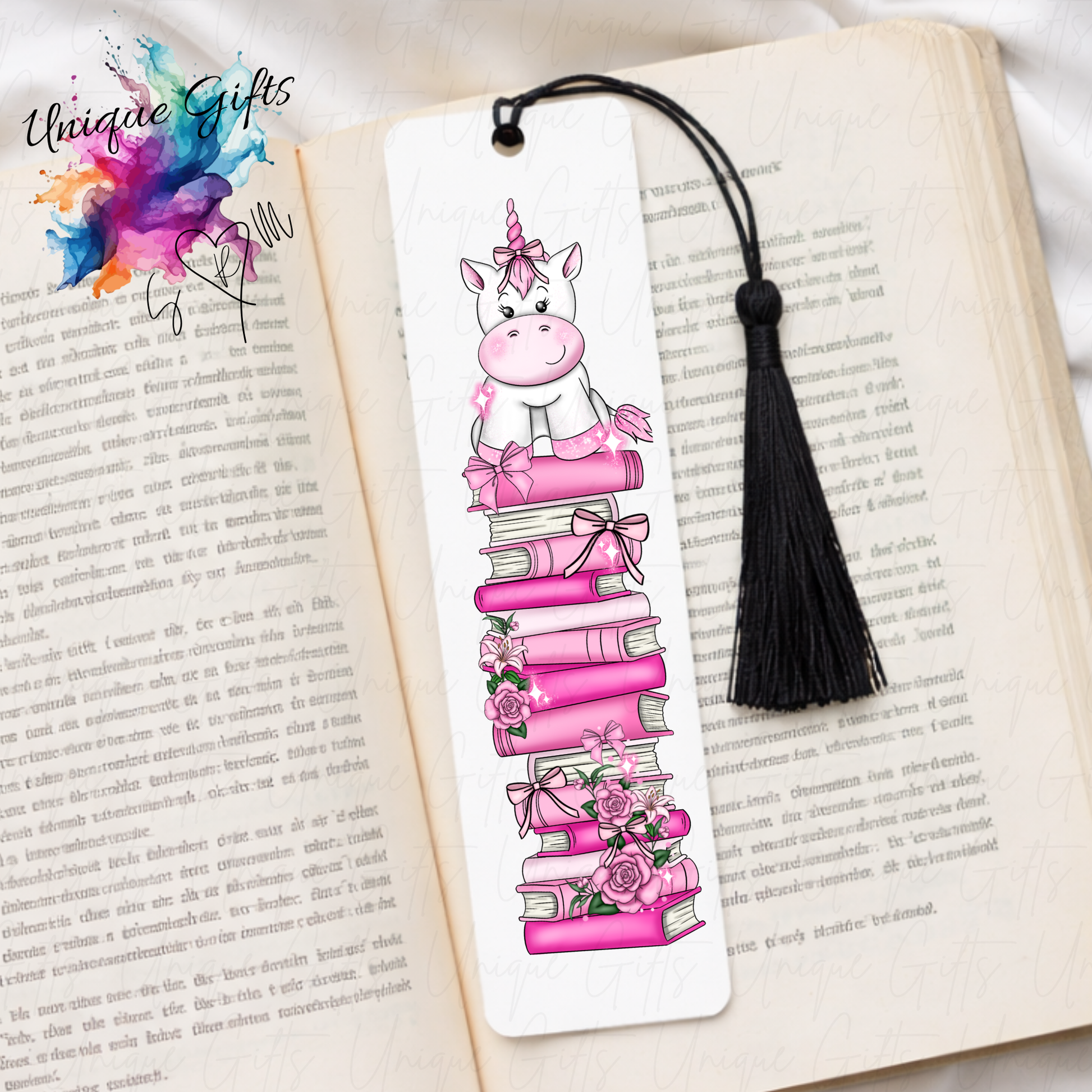 Personalised unicorn bookmark on pink book stack – magical reading gift – aluminium with black tassel