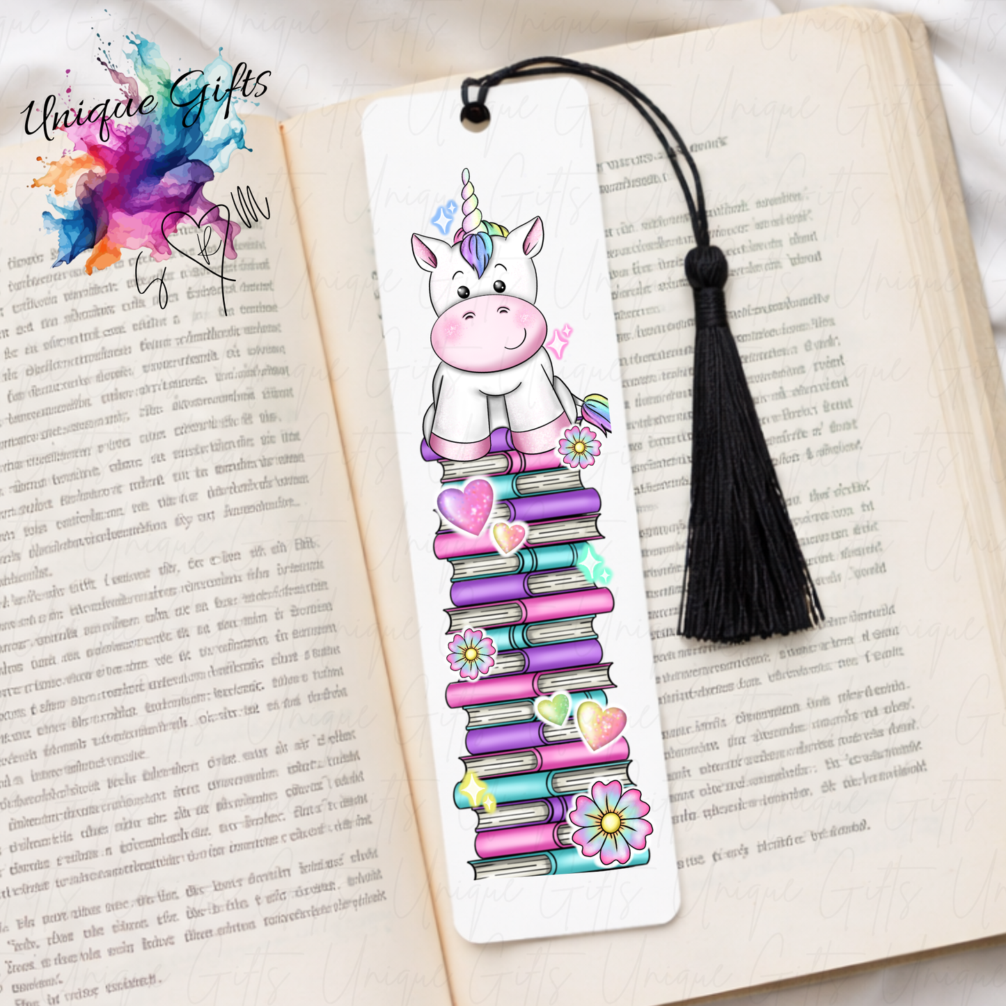 Personalised unicorn bookmark on colourful book stack – magical reading gift – aluminium with black tassel