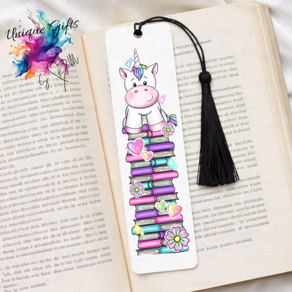 Personalised unicorn bookmark on colourful book stack – magical reading gift – aluminium with black tassel