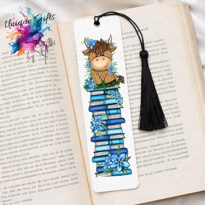 Personalised highland cow bookmark with blue flowers – book stack design – aluminium with black tassel
